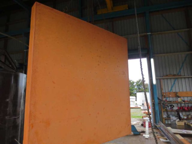 Workers installing precast concrete products on site